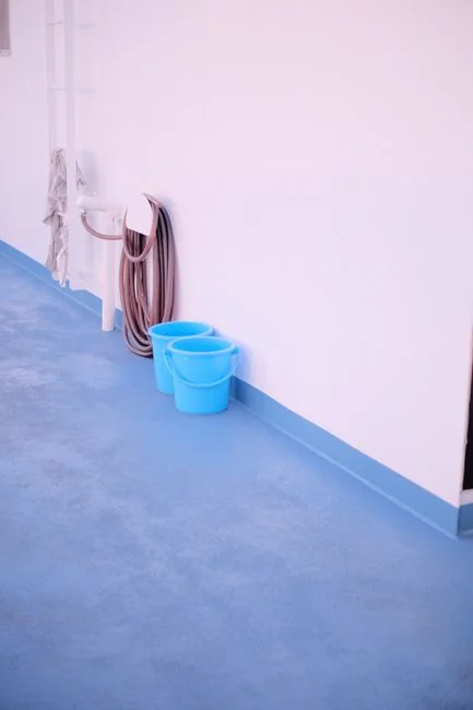 A professional housekeeper organizing pillows in a luxurious hotel room, maintaining service quality.